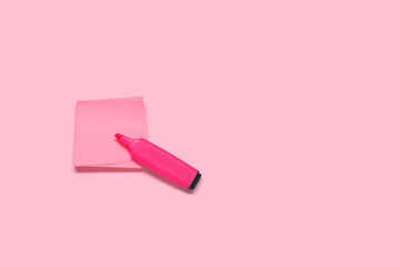 Sticky note with marker on pink background