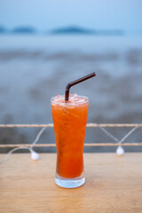 A glass of Mai Tai, a cocktail made of rum on the table with view of the beach