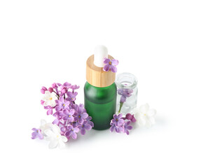 Fototapeta na wymiar Bottles of cosmetic oil with beautiful lilac flowers on white background