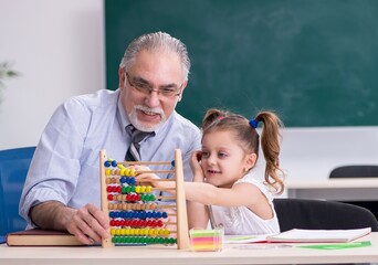 Old teacher and schoolgirl in the school