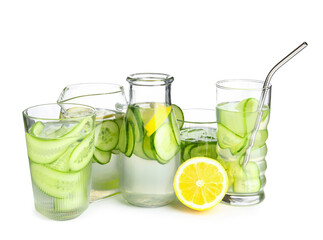 Glasses, bottle and jug of infused water with cucumber slices on white background