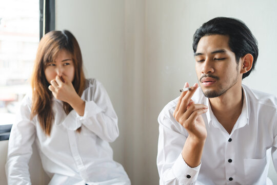 passive smoking effect, person cover his nose and avoid smoker near him