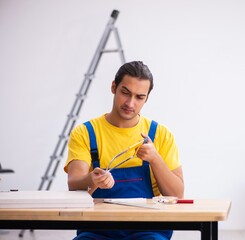 Young male carpenter working indoors