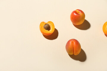 Fresh apricots on beige background