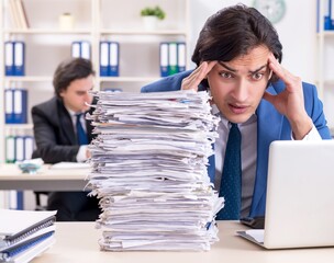 Two male colleagues unhappy with excessive work