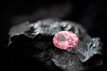 Natural loose pink sapphire gemstone on black coal background, Collection of natural gemstone