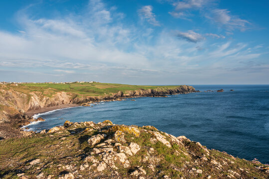 Beauitful sunrise and sunset landscape image of Kynance Cove in Cornwall England with colourful sky