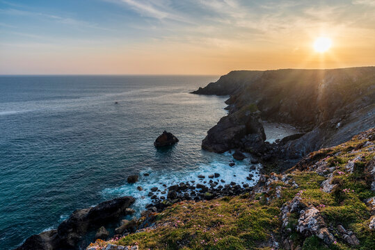 Beauitful sunrise and sunset landscape image of Kynance Cove in Cornwall England with colourful sky