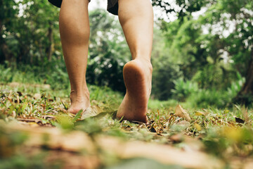 Man feet walking on the grass in the mountain.