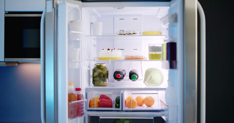 Open Refrigerator Full Of Juice And Fresh Vegetables