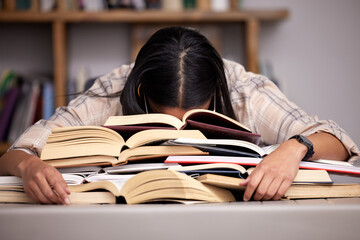 Study books, fatigue and woman student at desk with textbook for test feeling overworked. Stress, female person and home studying for university exam and course with burnout and sleeping in a house