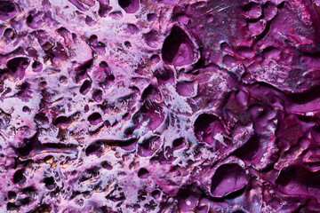 Decorative purple putty background. Wall texture with filler paste applied with spatula, chaotic...