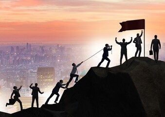 Concept of teamwork with team climbing mountain top