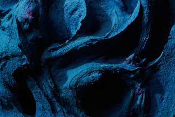 Decorative blue putty background. Wall texture with filler paste applied with spatula, chaotic...