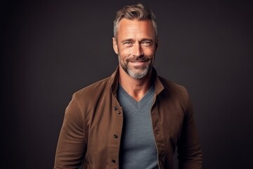 Obraz premium Medium shot portrait photography of a satisfied man in his 40s that is wearing a chic cardigan against a minimalist or empty room background . Generative AI