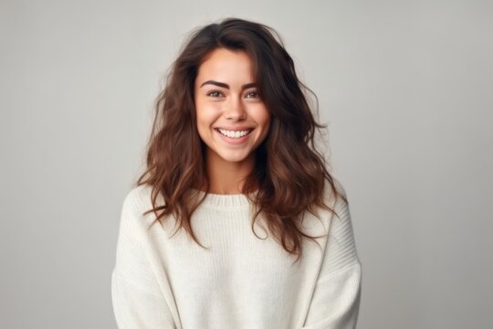 Medium shot portrait photography of a pleased woman in her 30s that is wearing a cozy sweater against a minimalist or empty room background . Generative AI