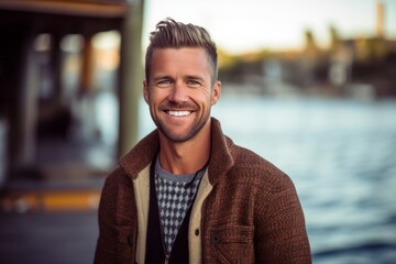 Fototapeta premium Portrait of a handsome young man smiling at the camera while standing outdoors