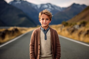 Fototapeta na wymiar portrait of a boy standing on a road in New Zealand alps