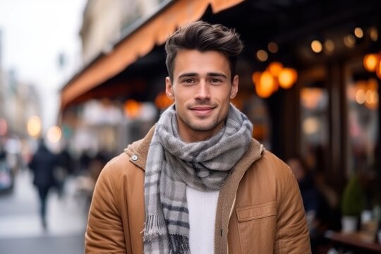 Medium shot portrait photography of a satisfied man in his 20s that is wearing a charming scarf against a parisian or european cafe background . Generative AI