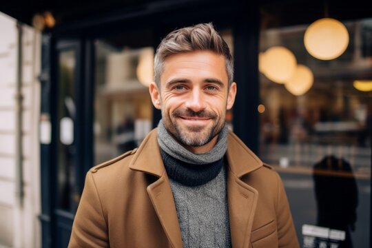 Medium Shot Portrait Photography Of A Grinning Man In His 30s That Is Wearing A Chic Cardigan Against A Parisian Or European Cafe Background . Generative AI