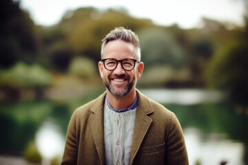 Portrait of a handsome mature man with eyeglasses smiling outdoors