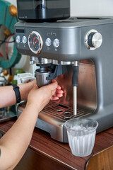 A barista is making a latte with an espresso machine