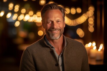 Obraz premium Portrait of a handsome middle-aged man smiling in a restaurant.