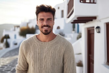 Portrait of handsome young man standing in the streets of Santorini