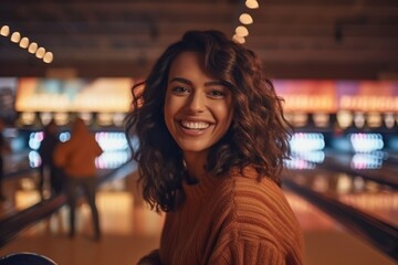 Medium shot portrait photography of a satisfied woman in her 30s that is wearing a cozy sweater against a noisy and animated bowling alley with friends background . Generative AI