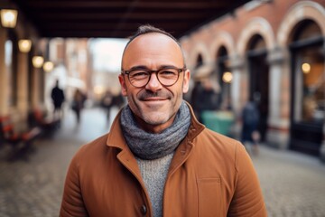 Fototapeta premium Portrait of a handsome middle-aged man with eyeglasses in a city street