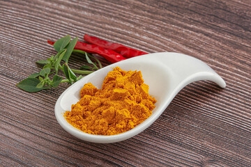 Yellow vibrant curcuma powder in the bowl
