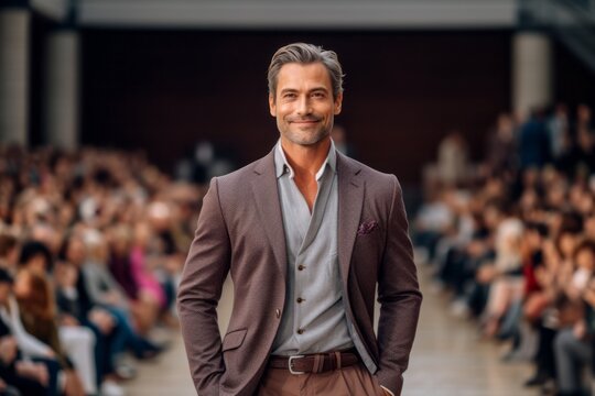 Medium shot portrait photography of a pleased man in his 40s that is wearing a chic cardigan against an elegant fashion show runway with models background . Generative AI