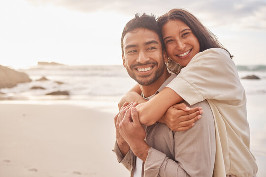 Love, portrait of couple and on the beach happy together with a lens flare. Care or support, summer vacation or holiday break and smile with young people at the sea for a romantic date outdoors