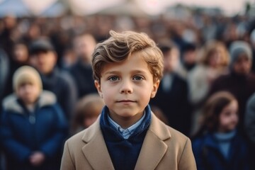 Portrait of a boy on the background of crowd of people.