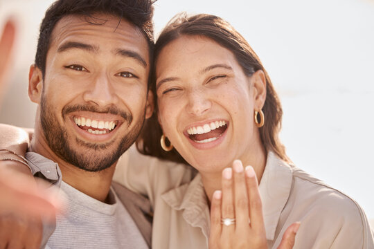 Couple in selfie, proposal and engagement ring with love and commitment, happy in portrait with social media post. Face, man and woman with marriage, happiness and care, smile in picture with jewelry