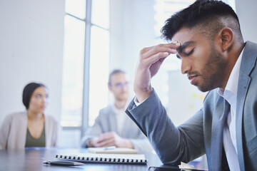 Mental health, businessman with a headache and at a business meeting with colleagues in a boardroom...