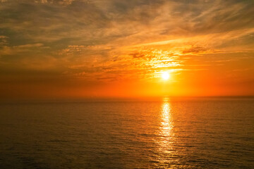 Fototapeta na wymiar Gorgeous panorama scenic strong sunrise cloud on orange sky.