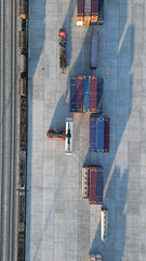 Aerial top down view crane loading container from container truck to container train, Cargo train...