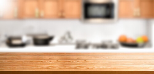 Table counter top with blur background of home cordial kitchen , modern style .