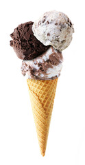 Triple scoop ice cream cone isolated on a white background. Cookies and cream, dark chocolate and...