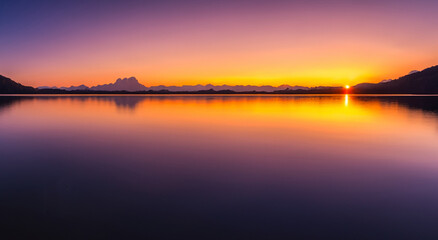 Fototapeta premium beautiful landscape in the autumn sunset with a lake reflected the sky