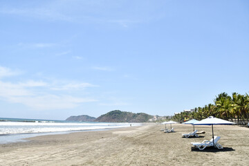 Fototapeta na wymiar beach with chairs and umbrellas, photo as a background