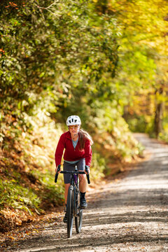 A woman gravel biking near the Blue Ridge Parkway in autumn, Pisgah North Carolina