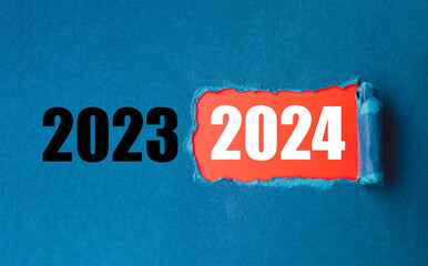 New year's change. End of 2023, start of 2024. 2024 surprise year out of torn paper