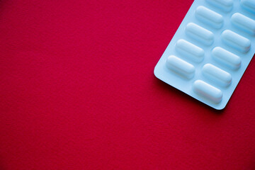 Pills. Medicines on a red background