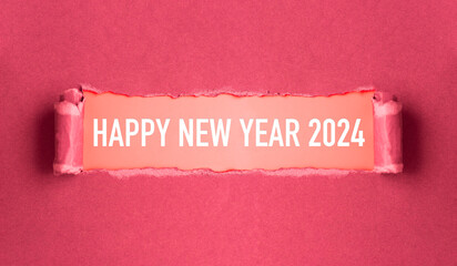New year concept. Torn pink cardboard that reads 'Happy New Year 2024'. 