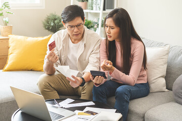 Stressed financial owe asian young couple love sitting suffer, stressed and confused by calculate expense from credit card bill, no money to pay, mortgage or loan. Debt, bankrupt or bankruptcy people.