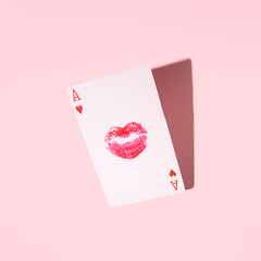 Play card ace of hearts , girl's kiss in the center, creative aesthetic love concept, pastel pink...