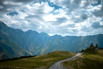 Fototapeta premium Mountain ranges on a sunny day at Georgia. Sky with clouds adn hills