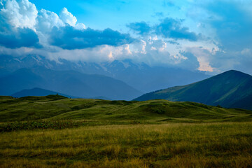 Mountain ranges on a sunny day at Georgia. Sky with clouds adn hills